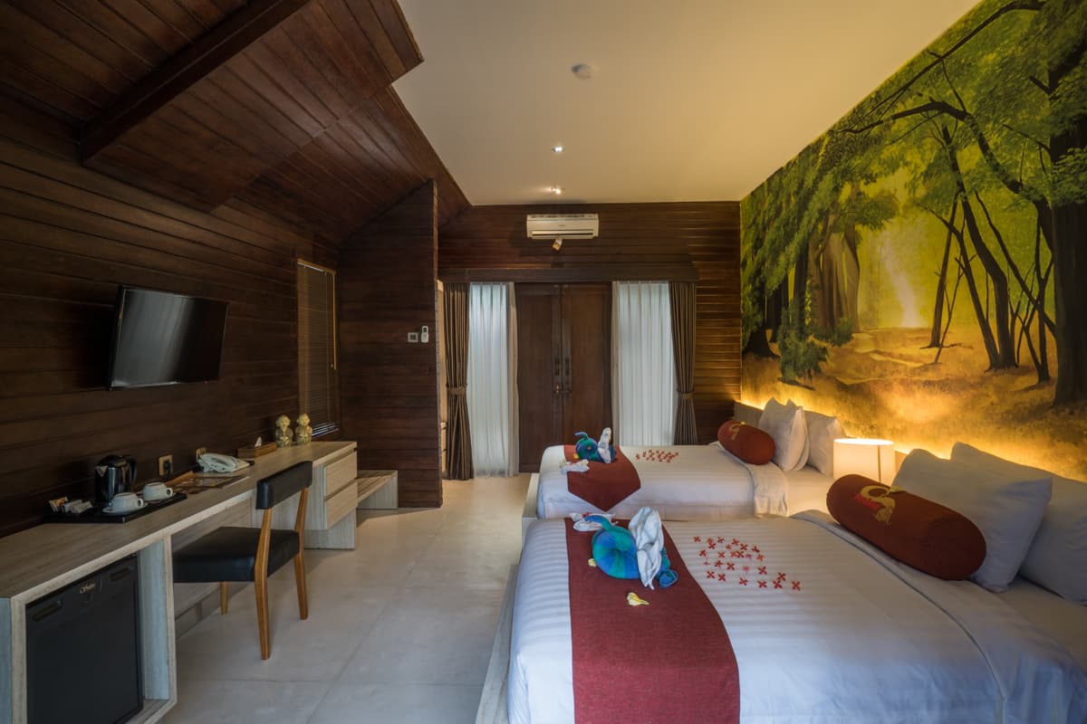 Hotel room with a tropical mural wall and a double bed
